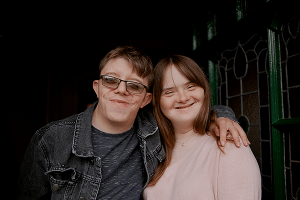 AdobeStock_459499861_young couple_smiling_posing_down syndrome_foetal alcohol syndrome_